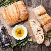 sliced bread ciabatta and extra virgin olive oil on wooden background